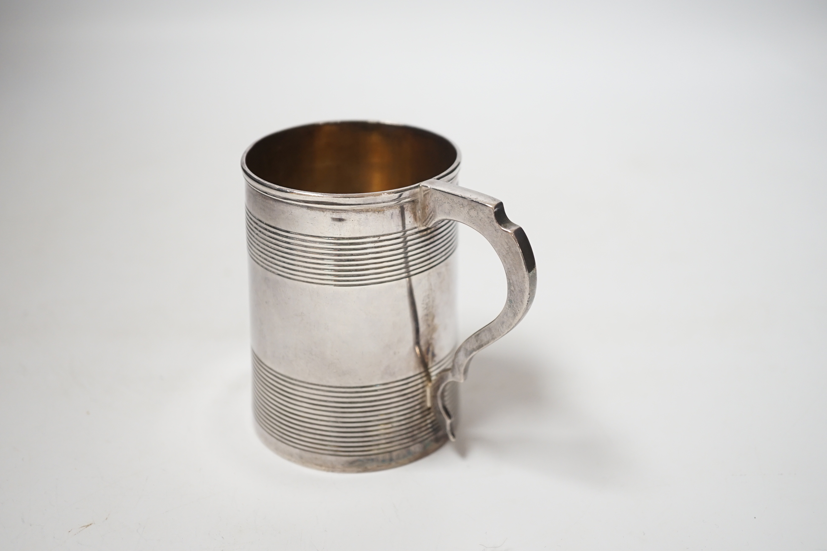 A George III reeded silver christening mug, Stephen Adam I, London, 1801, 85mm.